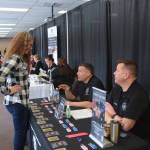 Sgt. Mike Jensen from the Anchorage Police Department talks to a participant of the Peninsula Job Fair at the Soldotna Regional Sports Complex in Soldotna, Alaska, on March 21, 2019. (Photo by Brian Mazurek/Peninsula Clarion)