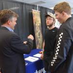 Florian Borowski with Schlumberger Oilfield Services speaks with potential recruits at the Peninsula Job Fair at the Soldotna Regional Sports Complex in Soldotna, Alaska, on March 21, 2019. (Photo by Brian Mazurek/Peninsula Clarion)