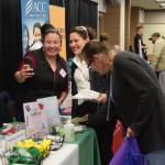 A Peninsula Community Health Services representative takes a selfie with a potential new hire during the Peninsula Job Fair at the Soldotna Regional Sports Complex in Soldotna, Alaska, on March 21, 2019. (Photo by Brian Mazurek/Peninsula Clarion)