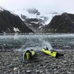 Two kayaks sit on a beach in Aialik Bay during a trip with Liquid Adventures kayaking company, based in Seward, in summer 2018. (Photo by Kat Sorensen/Peninsula Clarion)