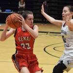 Kenais Logan Satathite (left) looks for an open teammate against ACSs Taylor Tiulana in front of her Friday, March 22, 2019, at the Class 3A girls state tournament at the Alaska Airlines Center in Anchorage. (Photo by Joey Klecka/Peninsula Clarion)