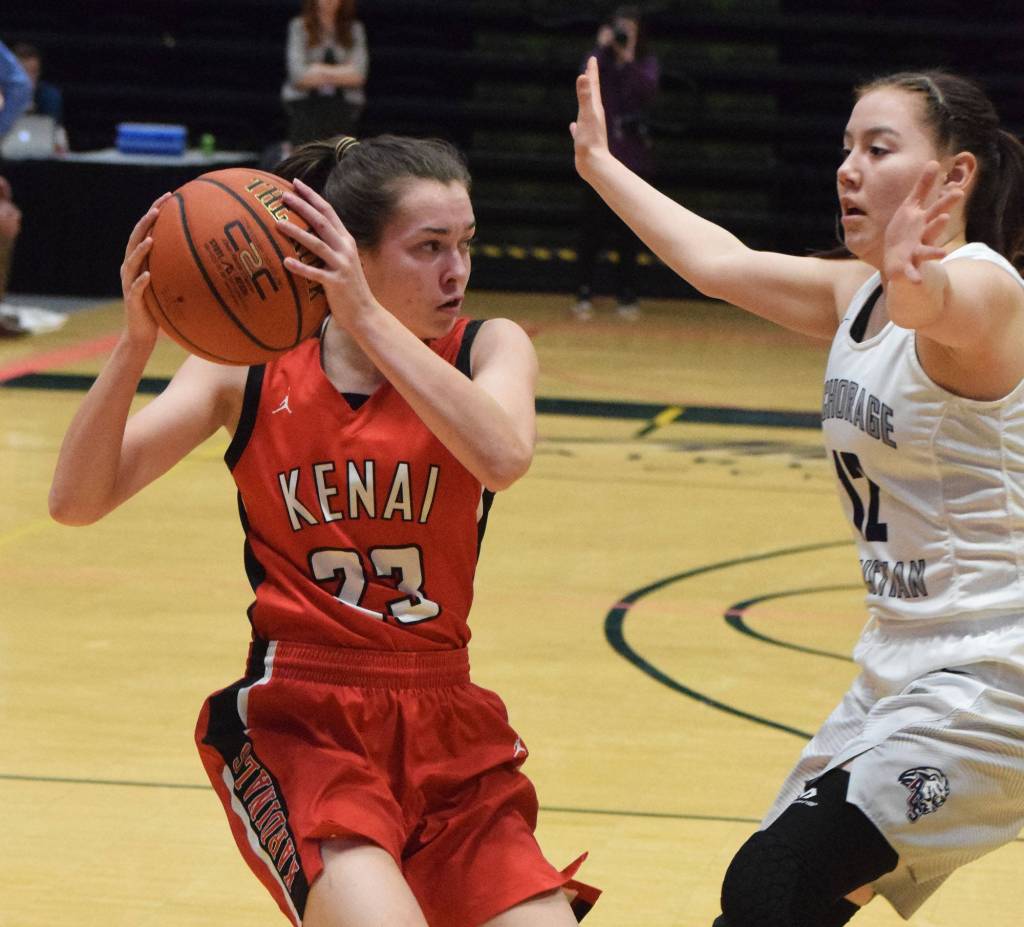 Kenais Logan Satathite (left) looks for an open teammate against ACSs Taylor Tiulana in front of her Friday, March 22, 2019, at the Class 3A girls state tournament at the Alaska Airlines Center in Anchorage. (Photo by Joey Klecka/Peninsula Clarion)