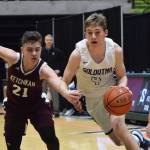 Soldotnas Tyler Morrison evades the grasp of Ketchikans Kristian Phil (left) Friday, March 22, 2019, at the Class 4A boys state tournament at the Alaska Airlines Center in Anchorage. (Photo by Joey Klecka/Peninsula Clarion)
