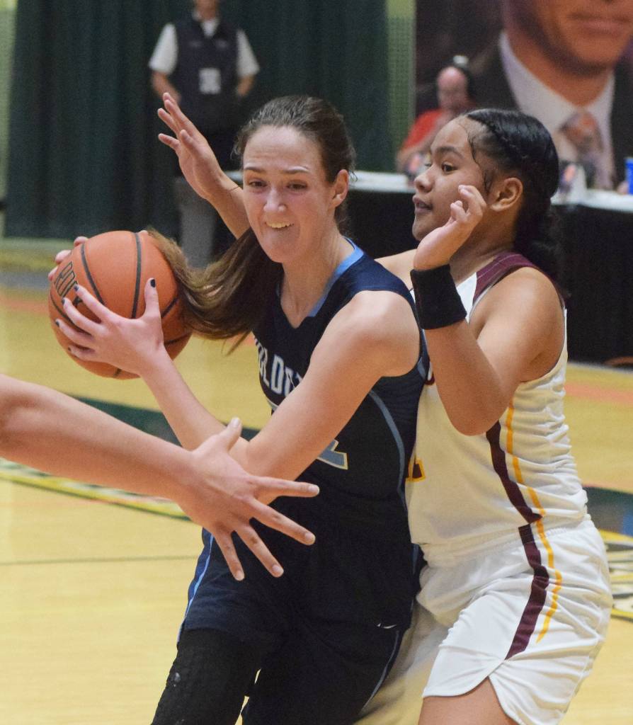 Soldotnas Danica Schmidt (left) drives into the lane by Dimonds Dshanna Schuster Friday, March 22, 2019, in the Class 4A state basketball tournament at the Alaska Airlines Center in Anchorage. (Photo by Joey Klecka/Peninsula Clarion)