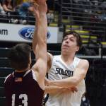 Soldotnas Jersey Truesdell (right) puts up a bucket over Ketchikans Cody Kemble Friday, March 22, 2019, at the Class 4A boys state tournament at the Alaska Airlines Center in Anchorage. (Photo by Joey Klecka/Peninsula Clarion)
