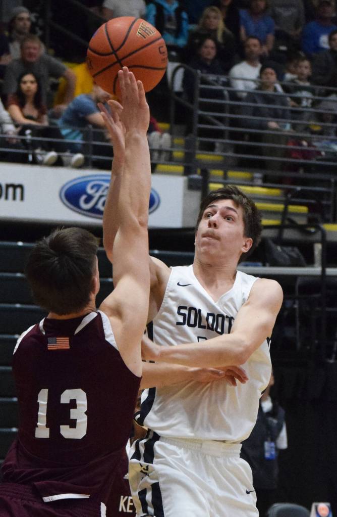 Soldotnas Jersey Truesdell (right) puts up a bucket over Ketchikans Cody Kemble Friday, March 22, 2019, at the Class 4A boys state tournament at the Alaska Airlines Center in Anchorage. (Photo by Joey Klecka/Peninsula Clarion)