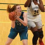 Nikiskis Kaycee Bostic (left) drives to the rim in front of ACSs Jordan Todd Saturday, March 23, 2019, in the Class 3A girls state basketball championship at the Alaska Airlines Center in Anchorage. (Photo by Joey Klecka/Peninsula Clarion)