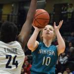 Nikiskis Lillian Carstens unleashes a 3-pointer Saturday, March 23, 2019, against ACS in the Class 3A girls state basketball championship at the Alaska Airlines Center in Anchorage. (Photo by Joey Klecka/Peninsula Clarion)