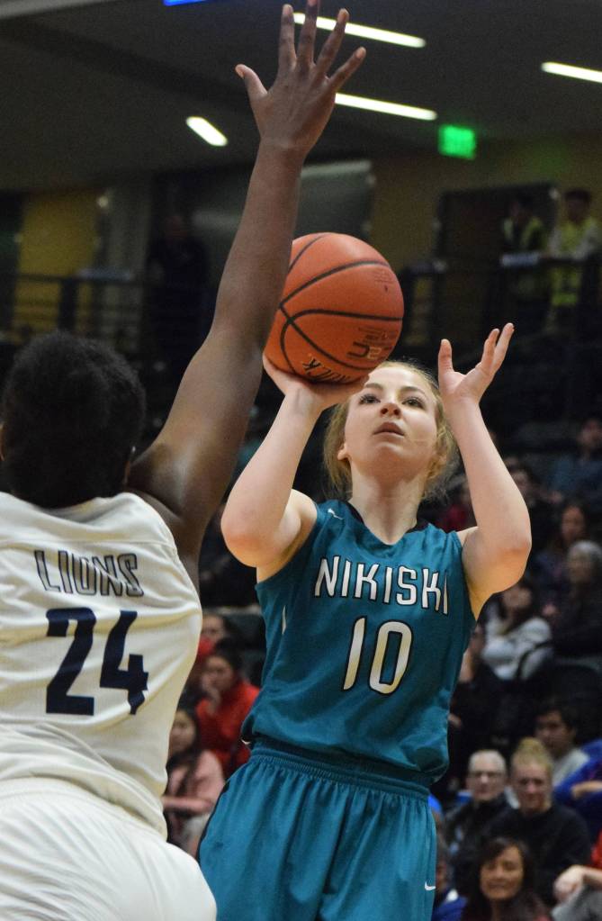 Nikiskis Lillian Carstens unleashes a 3-pointer Saturday, March 23, 2019, against ACS in the Class 3A girls state basketball championship at the Alaska Airlines Center in Anchorage. (Photo by Joey Klecka/Peninsula Clarion)