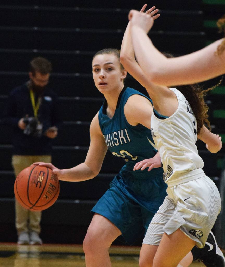 Nikiskis Bethany Carstens (left) dribbles by ACSs Mary Kate Parks Saturday, March 23, 2019, in the Class 3A girls state basketball championship at the Alaska Airlines Center in Anchorage. (Photo by Joey Klecka/Peninsula Clarion)