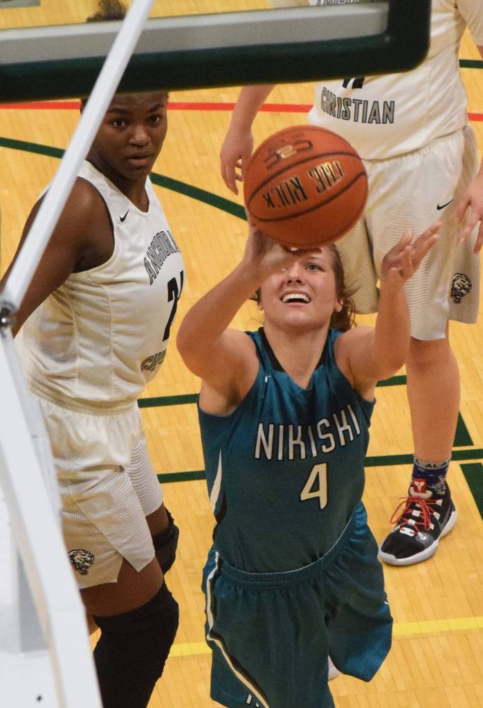 Nikiskis Emma Wik lays in a shot in front of ACSs Jordan Todd, Saturday, March 23, 2019, in the Class 3A girls state basketball championship at the Alaska Airlines Center in Anchorage. (Photo by Joey Klecka/Peninsula Clarion)