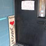 Messages of support surround the door to Wasabis Bistro on Thursday, March 21, 2019 in Homer, Alaska. Members of the community put up the signs and flocked to the restaurant last Thursday after the building was vandalized with racist graffiti. (Photo by Megan Pacer/Homer News)