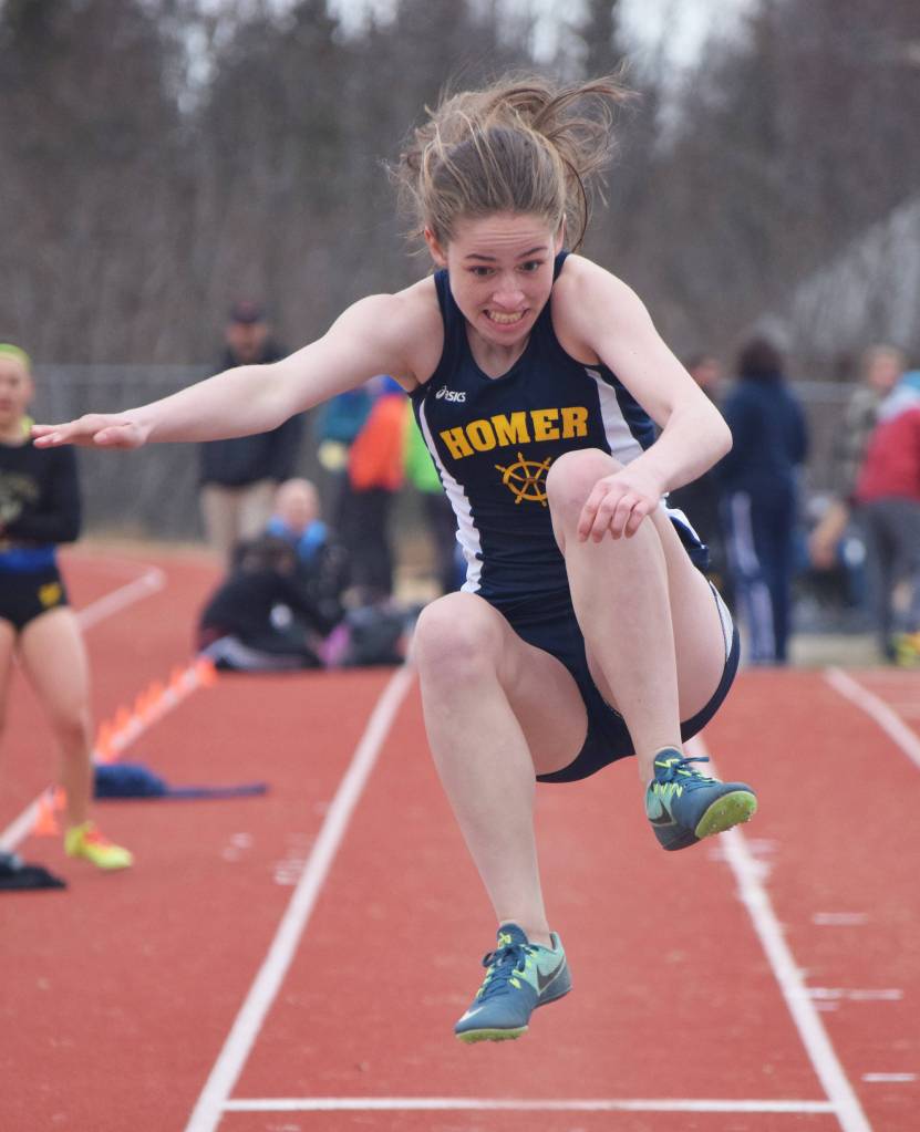 Homer freshman Laura Inama leaps into the sand pit in the girls long jump Saturday, April 21, 2018, at Homer High School. (Photo by Joey Klecka/Peninsula Clarion)