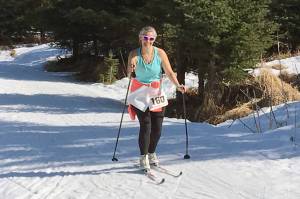 A skier from the womens team sarahlisa competes at the Sea to Ski Triathlon in Homer, Alaska, on Sunday, March 31, 2019. (Photo by Jeff Helminiak/Peninsula Clarion)
