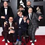 In this Jan. 28, 2018 file photo, from left, Zachary Scott Carothers, John Gourley, Eric Howk, Zoe Manville, Jason Wade Sechrist and Kyle OQuin of Portugal. The Man arrive at the 60th annual Grammy Awards at Madison Square Garden in New York. The state of Alaskas new hold music is on hold. A project to replace the sleepy hold music for state office lines with music by Alaska artists drew widespread attention when it was announced in November, touting Portugal. The Man and four other artists with Alaska ties. A spokesman for Gov. Mike Dunleavy says it was muted shortly thereafter after concerns with some of the music were raised by the public.(Photo by Evan Agostini/Invision/AP, File)