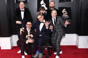 In this Jan. 28, 2018 file photo, from left, Zachary Scott Carothers, John Gourley, Eric Howk, Zoe Manville, Jason Wade Sechrist and Kyle OQuin of Portugal. The Man arrive at the 60th annual Grammy Awards at Madison Square Garden in New York. The state of Alaskas new hold music is on hold. A project to replace the sleepy hold music for state office lines with music by Alaska artists drew widespread attention when it was announced in November, touting Portugal. The Man and four other artists with Alaska ties. A spokesman for Gov. Mike Dunleavy says it was muted shortly thereafter after concerns with some of the music were raised by the public.(Photo by Evan Agostini/Invision/AP, File)