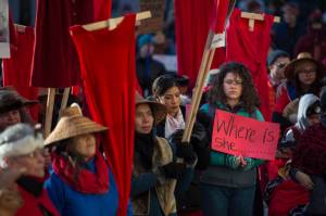 Native women hold up red dresses to symbolize missing and murdered indigenous women during the Womens March on Juneau in front of the Alaska State Capitol on Saturday, Jan. 19, 2019. (Michael Penn | Juneau Empire)