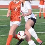 Kenais Rileigh Pace (right) manuevers the ball around West defender Jamey Roy (12) Thursday, April 4, 2019, in a nonconference game at Kenai Central High School. (Photo by Joey Klecka/Peninsula Clarion)