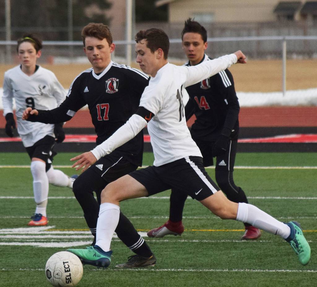 Kenais Travis Verkuilen (17) works on blocking Wests Jack Green from a shot Thursday, April 4, 2019, in a nonconference game at Kenai Central High School. (Photo by Joey Klecka/Peninsula Clarion)