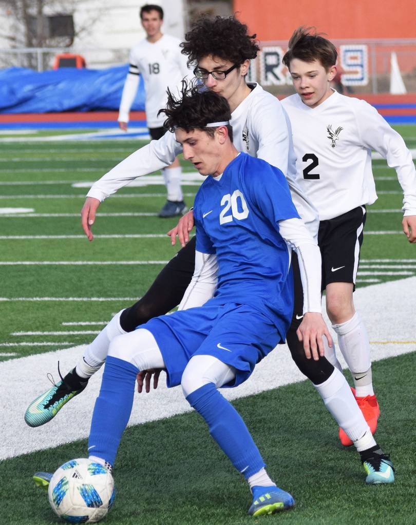 Soldotnas Josh Heiber (20) defends from West Anchorages Amine Benarroudj, Friday, April 5, 2019, in a nonconference contest at Soldotna High School. (Photo by Joey Klecka/Peninsula Clarion)