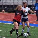 Kenai Centrals Damaris Severson (left) battles for the ball with Soldotnas Sierra Kuntz last season in the Peninsula Conference girls soccer championship at Soldotna High School. (Photo by Joey Klecka/Peninsula Clarion)