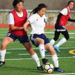 Soldotnas Meijan Leaf fights to keep possession of the ball under pressure from Homers Alyssum Veldstra during a Tuesday game in Homer. The teams tied the game 3-3. (Photo by Megan Pacer/Homer News)