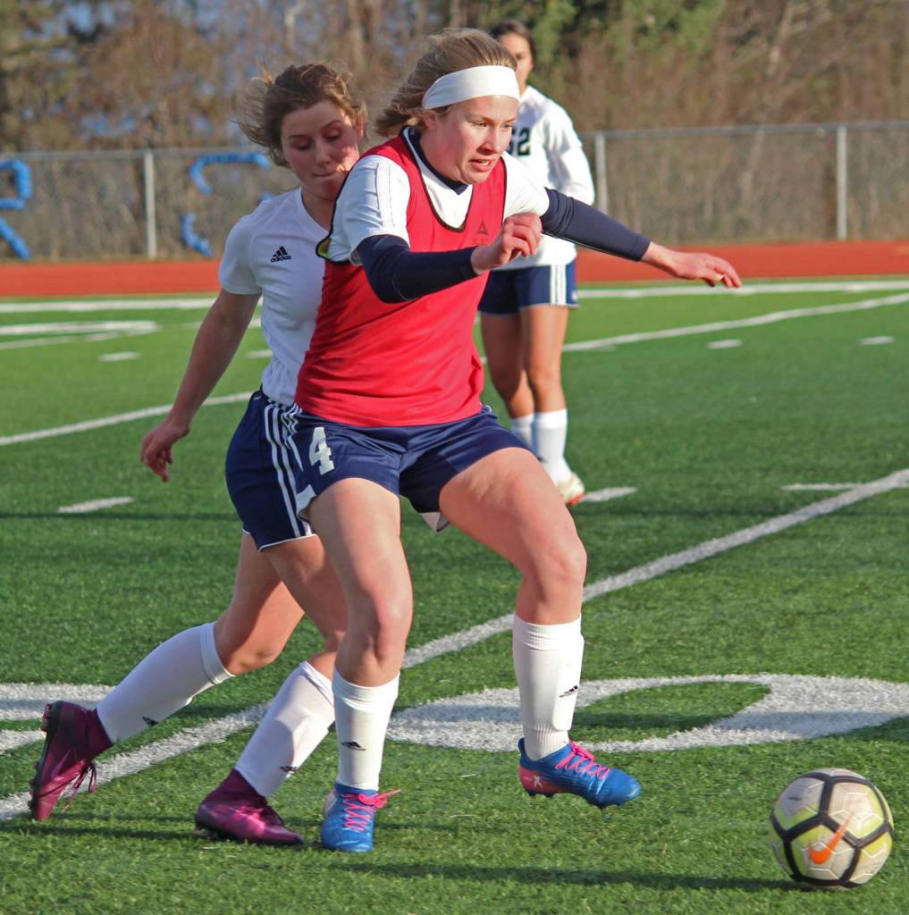 Homers Jessica Sonnen fights to keep the ball from Soldotna High School possession during a Tuesday game in Homer. The teams tied 3-3. (Photo by Megan Pacer/Homer News)