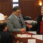 Rep. Tammie Wilson, R-North Pole, right, speaks to other representatives on the House of Representatives floor on Wednesday. (Alex McCarthy | Juneau Empire)