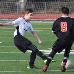 Nikiskis Jordan Flemming (left) attempts to keep a ball away from Kenais Koa Diorec Thursday in a Peninsula Conference clash at Kenai Central High School. (Photo by Joey Klecka/Peninsula Clarion)