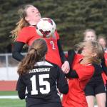 Kenais Bethany Morris (2) jumps up to reach a ball Thursday against Nikiski in a Peninsula Conference clash at Kenai Central High School. (Photo by Joey Klecka/Peninsula Clarion)