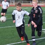 Nikiskis Gavin White (4) battles for the ball with Kenais Leif Lofquist Thursday in a Peninsula Conference clash at Kenai Central High School. (Photo by Joey Klecka/Peninsula Clarion)
