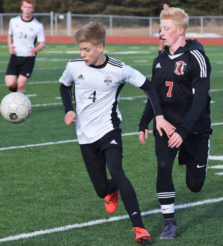 Nikiskis Gavin White (4) battles for the ball with Kenais Leif Lofquist Thursday in a Peninsula Conference clash at Kenai Central High School. (Photo by Joey Klecka/Peninsula Clarion)