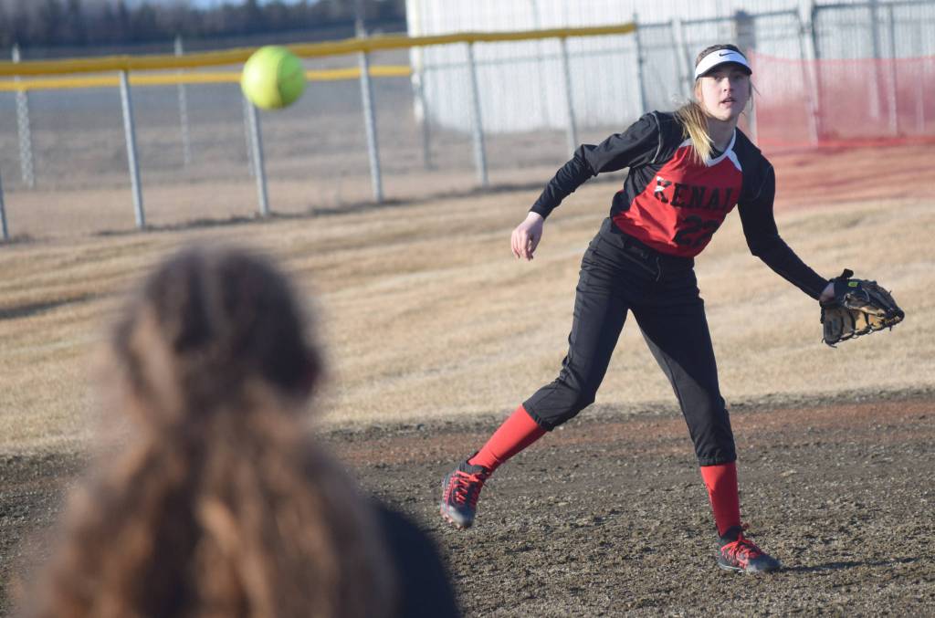 Kenai Central shortstop Zaharah Wilshusen throws to first baseman Lexi Reis for an out Friday, April 12, 2019, at Steve Shearer Memorial Ball Park in Kenai, Alaska. (Photo by Jeff Helminiak/Peninsula Clarion)