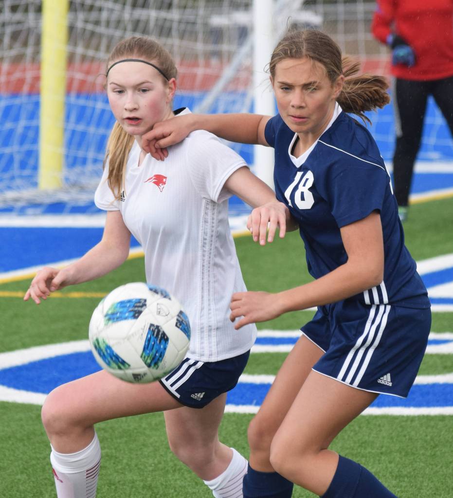 Soldotnas Jordan Strausbaugh (18) battles with North Poles Chalayna Culler Friday, April 12, 2019, in a nonconference game at Soldotna High School. (Photo by Joey Klecka/Peninsula Clarion)