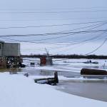 In this Feb. 12, 2019 photo provided by Philomena Keys, high water pushed up the Yukon River from the Bering Sea floods yards around homes in the western village of Kotlik, Alaska. Warm winds in February melted or pushed away Bering Sea ice, leaving coastal villages vulnerable to winter flooding. (Philomena Keys via AP)