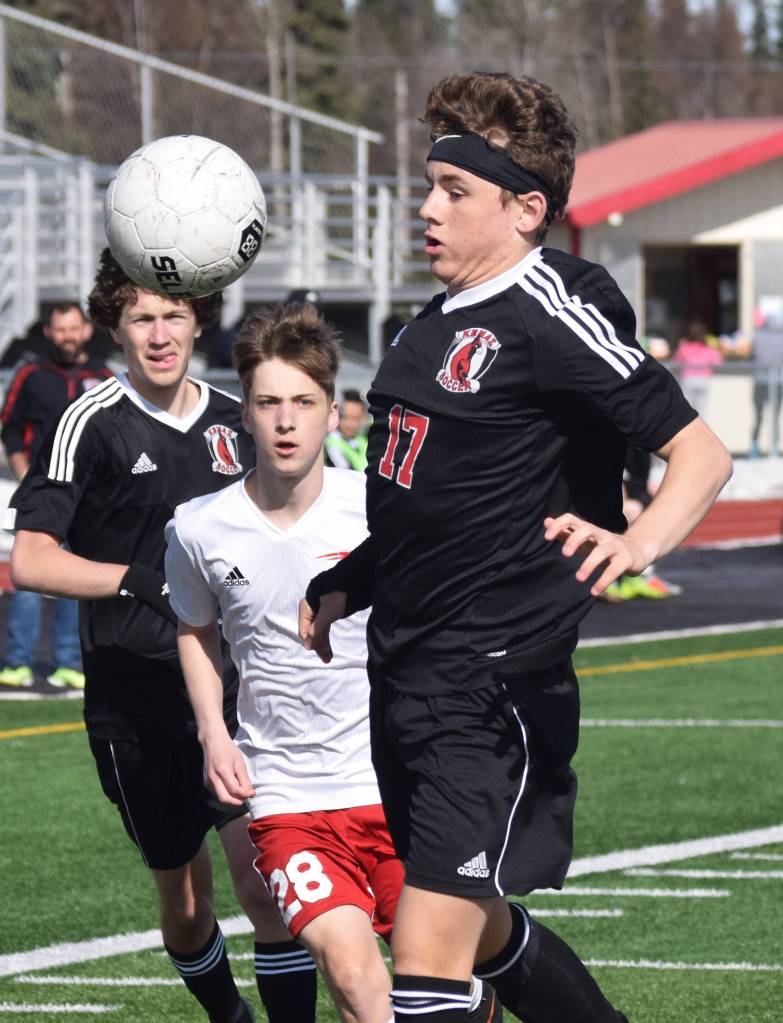 Kenais Travis Verkuilen (17) gets his chest on a ball Saturday, April 13, 2019, in a nonconference game against North Pole at Kenai Central High School. (Photo by Joey Klecka/Peninsula Clarion)
