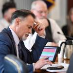 Sen. Peter Micciche, R-Soldotna, works a calculator as he and Sen. Bert Stedman, R-Sitka, listen to public testimony on the state budget in the Senate Finance Committee hearing on Friday, April 12, 2019. (Michael Penn | Juneau Empire)
