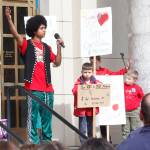 Juneau-Douglas High School senior Arias Hoyle speaks at the Fund Our Future rally on the steps of the Alaska State Capitol on Saturday. (Alex McCarthy | Juneau Empire)