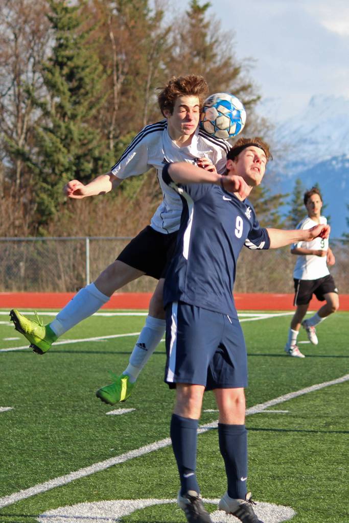 Kenais Francisco Garmen Munarriz jumps for a the same ball as Homers Avram Salzmann during a Tuesday, April 16, 2019 game at Homer High School in Homer, Alaska. (Photo by Megan Pacer/Homer News)