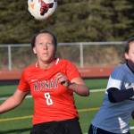 Kenai Centrals Anya Danielson prepares to clear the ball in front of Homers Jessica Sonnen on Tuesday, April 16, 2019, at Kenai Central High School in Kenai, Alaska. (Photo by Jeff Helminiak/Peninsula Clarion)