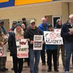 Protesters stand in the Homer High School Commons at the end of a rally held by Cook Inletkeeper at the same time as a April 11, 2019 public hearing hosted by the Army Corps of Engineers to take comments on the Draft Environmental Impact Statement for the proposed Pebble Mine, held at the high school in Homer, Alaska. The protesters marched from their rally outside the school into the commons with the intention of marching into the hearing. (Photo by Megan Pacer/Homer News)