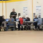 Community members submit comments about the Draft EIS for the proposed Pebble Mine to the Army Crops of Engineers through computers set up at an April 11, 2019 public hearing at Homer High School in Homer, Alaska. (Photo by Megan Pacer/Homer News)