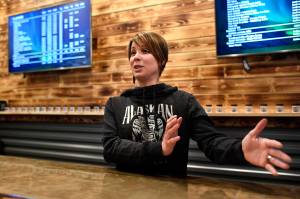 Amy Herrick, manager at the Alaskan Kush Company downtown retail store, talks about the possibility of opening an onsite consumption space on Tuesday, April 16, 2019. (Michael Penn | Juneau Empire)