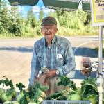 Dale Cocklin of Two Peas in a Pod Farm sells an abundance of root vegetables like beets, kohlrabi, carrots and more at his stand at the Tuesday, Aug. 28. 2018 Farmers Fresh Market at the Kenai Peninsula Food Bank, near Soldotna, Alaska. (Photo by Victoria Petersen/Peninsula Clarion)