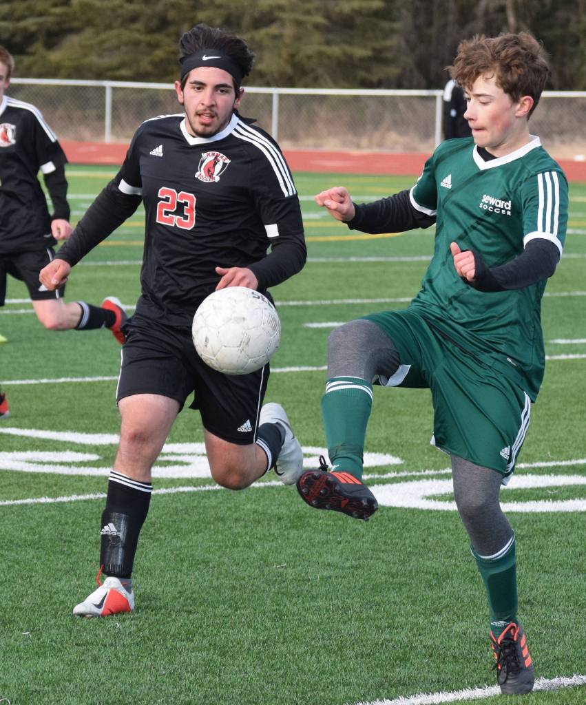 Kenais Jacob Howard works to get the ball from a Seward player Tuesday in a conference clash at Kenai Central High School. (Photo by Joey Klecka/Peninsula Clarion)