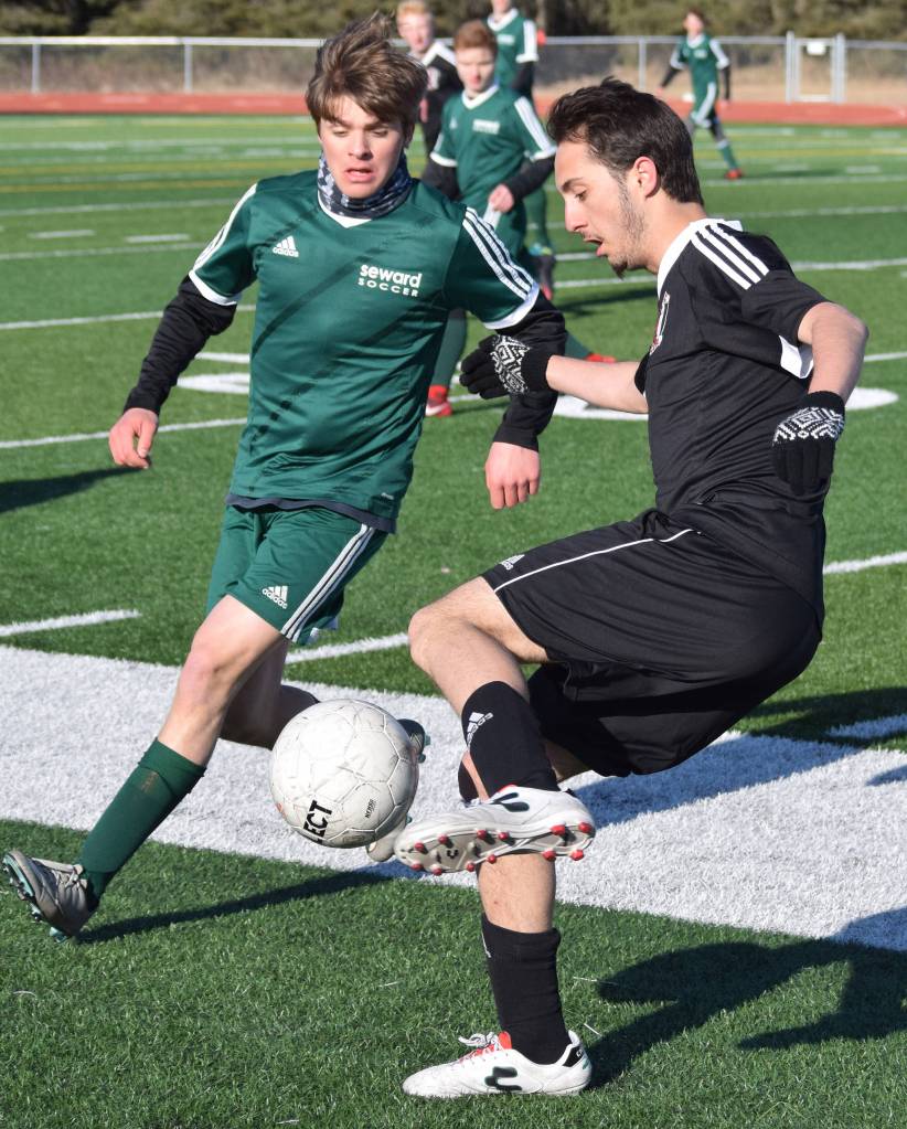 Kenais Tomas Levy-Canedo (right) maneuvers around Sewards Samuel Koster Tuesday in a conference clash at Kenai Central High School. (Photo by Joey Klecka/Peninsula Clarion)