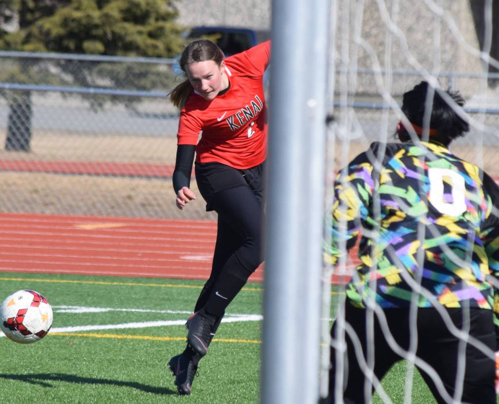 Kenais Bethany Morris sends a shot on Seward goalkeeper Makaira Williams Tuesday in a conference clash at Kenai Central High School. (Photo by Joey Klecka/Peninsula Clarion)