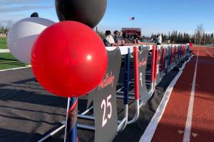 A row of handmade signs depicting the names of the senior class line the Kenai Central bench Tuesday night against Seward at Kenai Central High School. (Photo by Joey Klecka/Peninsula Clarion)