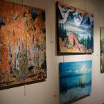 Some of John Fenskes paintings at the First Friday, April 5, 2019, opening for his retrospective showing at Kachemak Bay Campus in Homer, Alaska. (Photo by Michael Armstrong/Homer News)