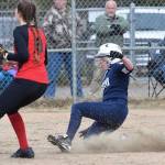 Soldotnas Bailey Berger slides home safe in front of Kenai Centrals Lexi Reis, Thursday, April 25, 2019, at the Soldotna Softball Fields. (Photo by Joey Klecka/Peninsula Clarion)